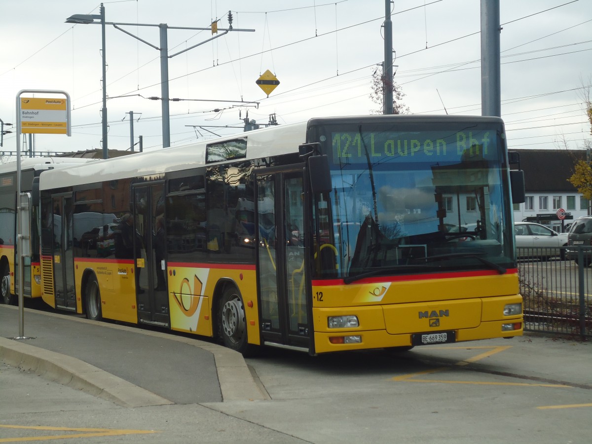 (148'167) - Klopfstein, Laupen - Nr. 12/BE 669'359 - MAN (ex STB Laupen Nr. 32) am 25. November 2013 beim Bahnhof D�dingen