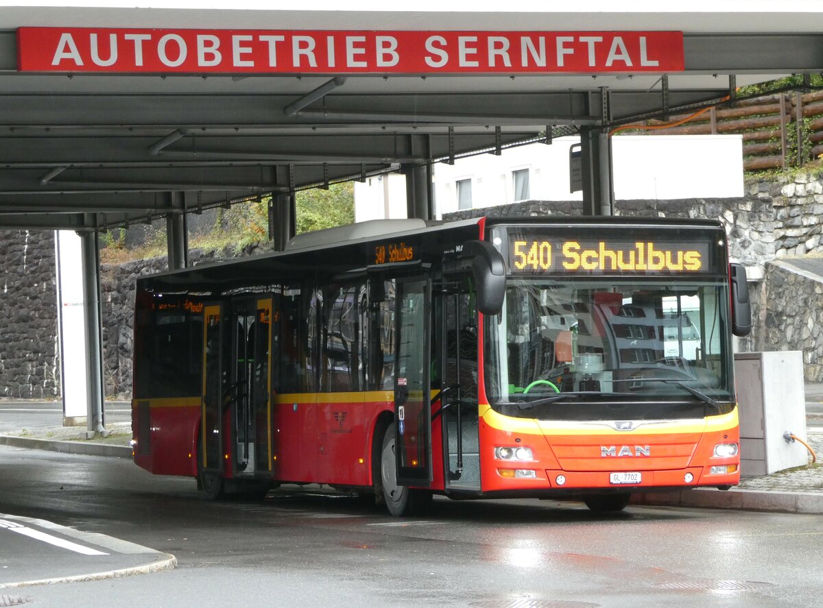 (256'605) - AS Engi - Nr. 2/GL 7702 - MAN (ex Gessert, D-Finsterbergen; ex Herrmann, D-Sch�nau vor dem Walde) am 31. Oktober 2023 beim Bahnhof Schwanden